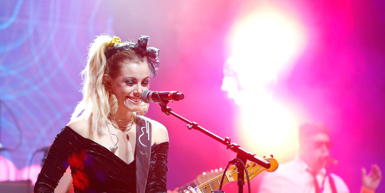 Lindsay Ell plays guitar onstage, with her hair in an '80s side ponytail.
