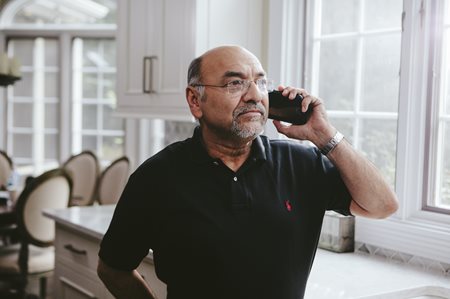 Older adult calling on a cell phone.