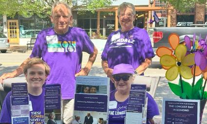 Volunteers work an Alzheimer's Association information table
