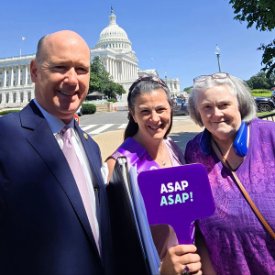 Stephanie, holding a purple ASAP sign, and two other advocates standing in front of the U.S. Capitol building