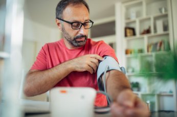 Man uses blood pressure cuff