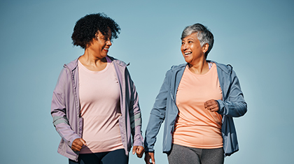 Two women walking together happily