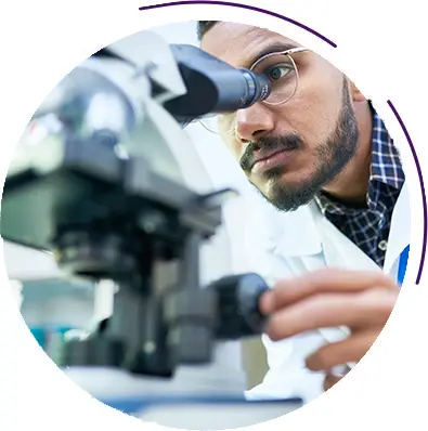 Researcher looking at microscope slide
