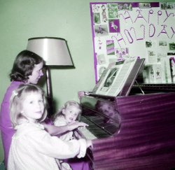 Joan plays piano with her daughters