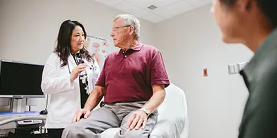 A doctor explains the latest Alzheimer's research to a patient