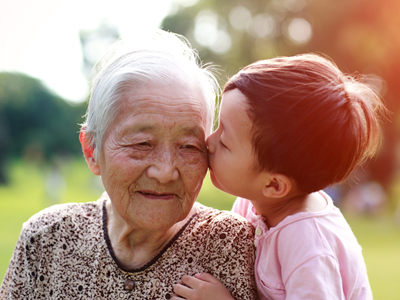 Young child kisses elderly respite care resident