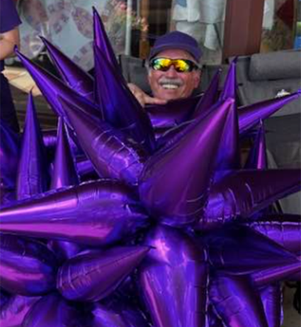 A man in a purple star costume