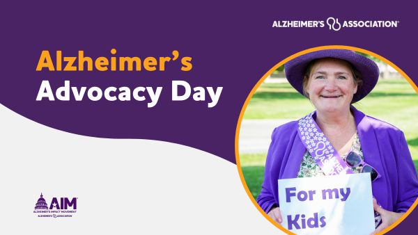 Alzheimer's Advocacy Day. A woman in purple holds a sign saying "For my kids"