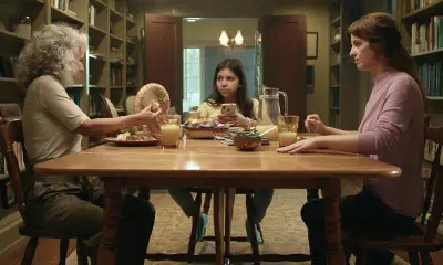 Family of 3 eating and discussing at table