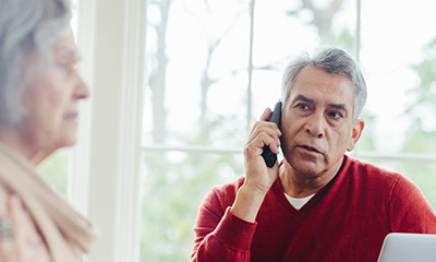 A Hispanic man talking on the phone