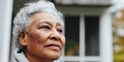 An older Black woman, looking out confidently