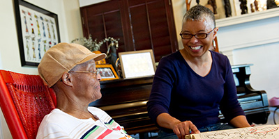 Two Black women talking and smiling