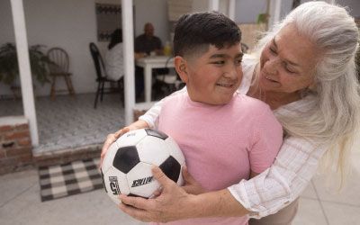 Boy and parent holding soccer ball